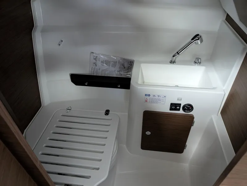 Slide: The Image of 2024 Jeanneau NC795 S2 boat interior with compact sink and toilet. - 5