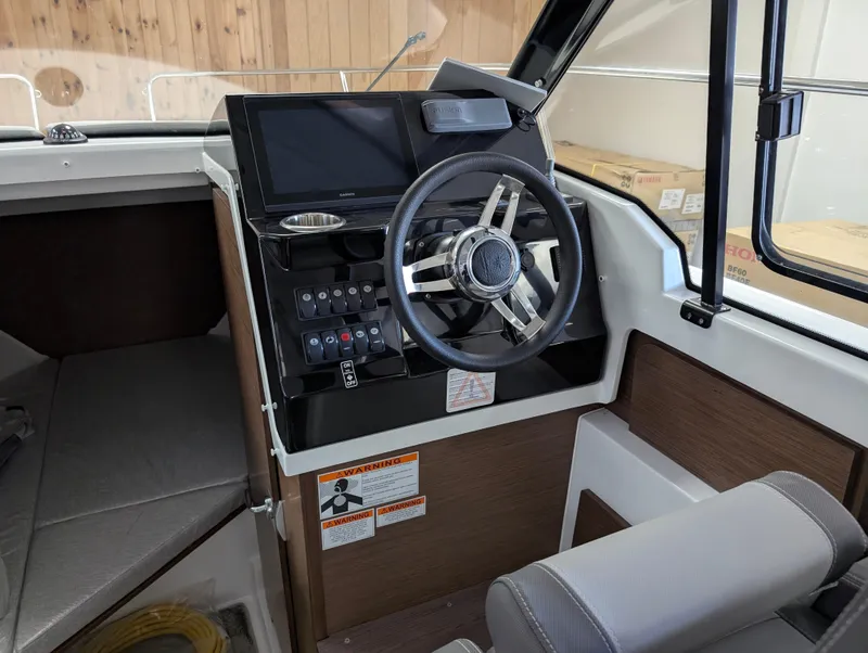 Slide: The Image of 2024 Jeanneau NC795 S2 helm with modern steering and control panel. - 7