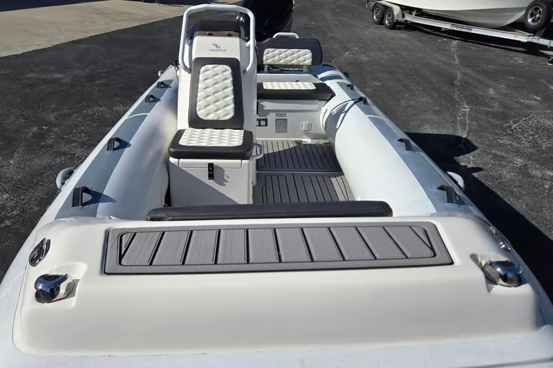 Slide: The Image of 2024 Highfield Sport 460 boat interior with cushioned seating and sleek design. - 17