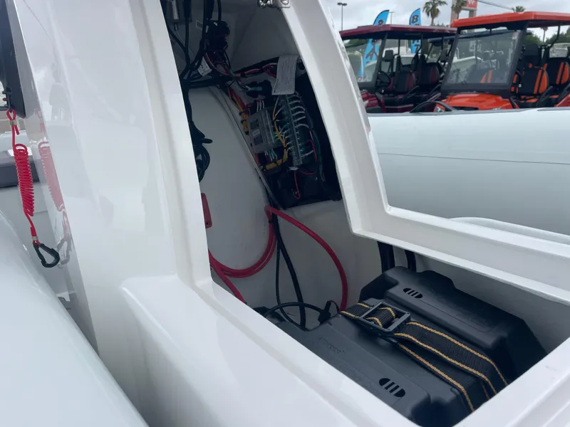 Slide: The Image of 2024 Highfield Sport 460 boat with outboard motor on a trailer, parked outdoors. - 4