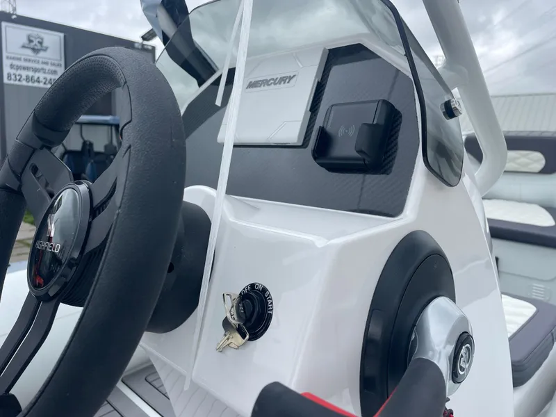 Slide: The Image of 2024 Highfield Sport 460 boat on trailer, parked outside a warehouse. - 6