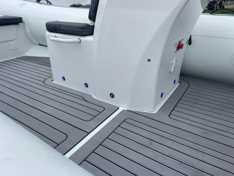 Slide: The Image of 2024 Highfield Sport 460 boat on trailer, parked in a marina lot. - 7