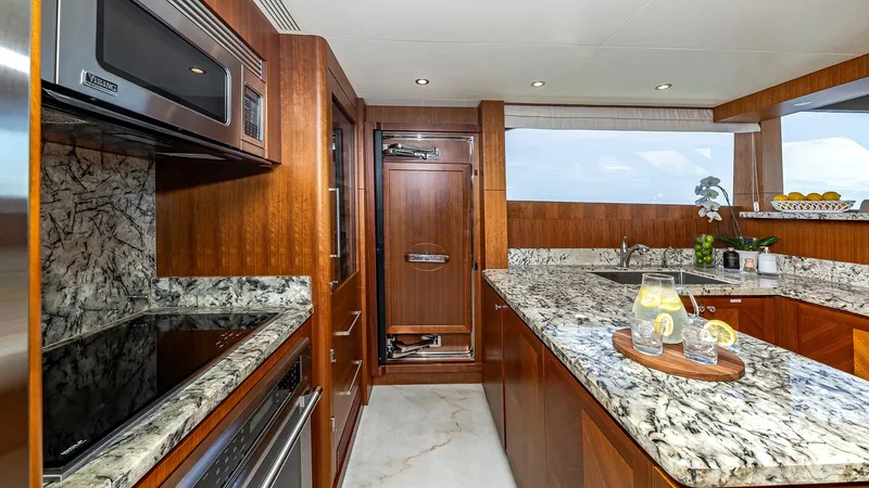 Slide: The Image of Luxurious kitchen in 2015 Ocean Alexander Motoryacht Open Bridge with granite countertops. - 25