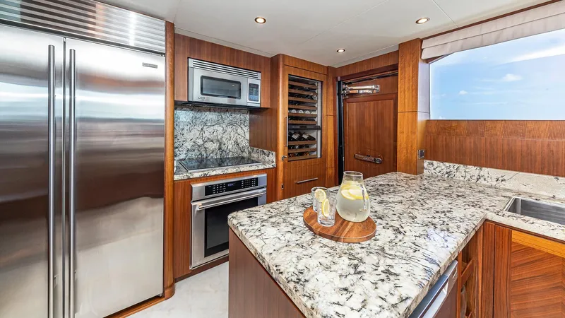 Slide: The Image of Luxurious kitchen in a 2015 Ocean Alexander Motoryacht Open Bridge with granite countertops. - 26