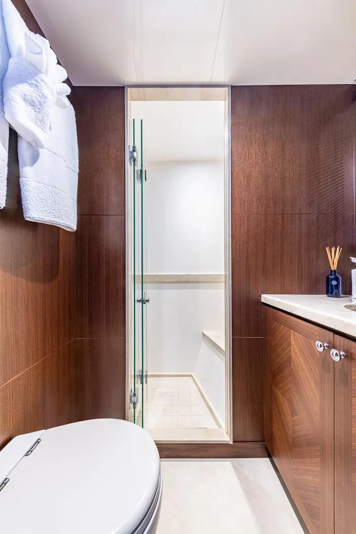 Slide: The Image of 2015 Ocean Alexander Motoryacht Open Bridge bathroom with wood paneling and glass shower door. - 41