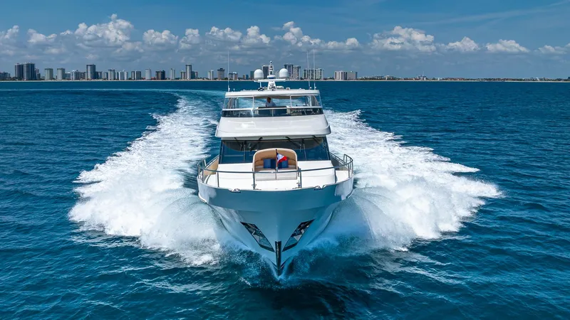 Slide: The Image of 2015 Ocean Alexander Motoryacht Open Bridge cruising on blue ocean near city skyline. - 5