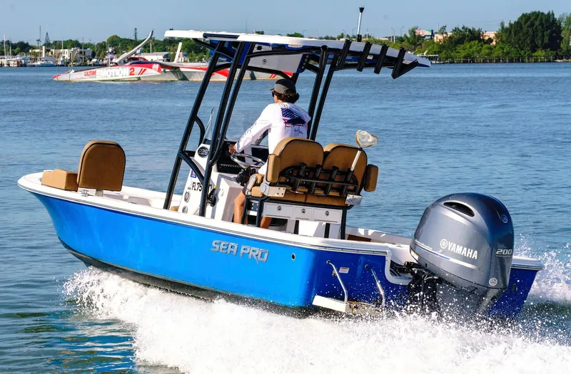 Slide: The Image of 2023 Sea Pro 228 Center Console boat cruising on water with Yamaha engine. - 0
