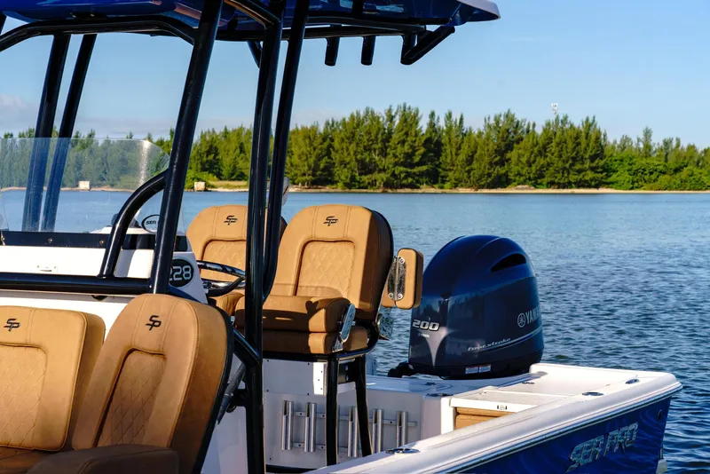 Slide: The Image of 2023 Sea Pro 228 Center Console boat with Yamaha engine on calm water. - 2