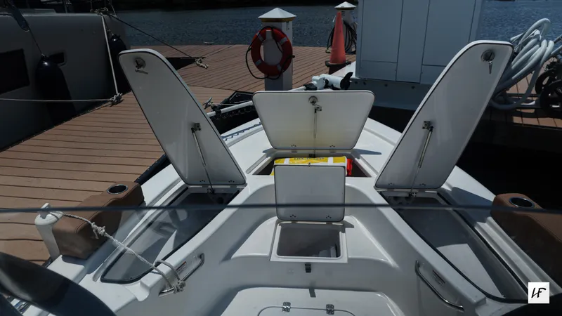 Slide: The Image of 2023 Sea Pro 228 Center Console boat with open storage compartments at the dock. - 4