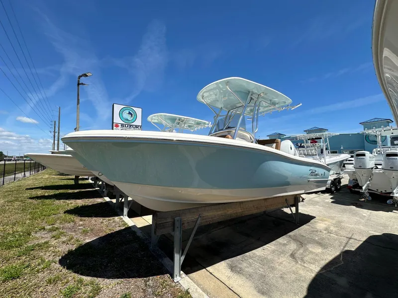 The Image of 2024 Pioneer 222 Sport Fish boat displayed outdoors under a clear sky. - 1