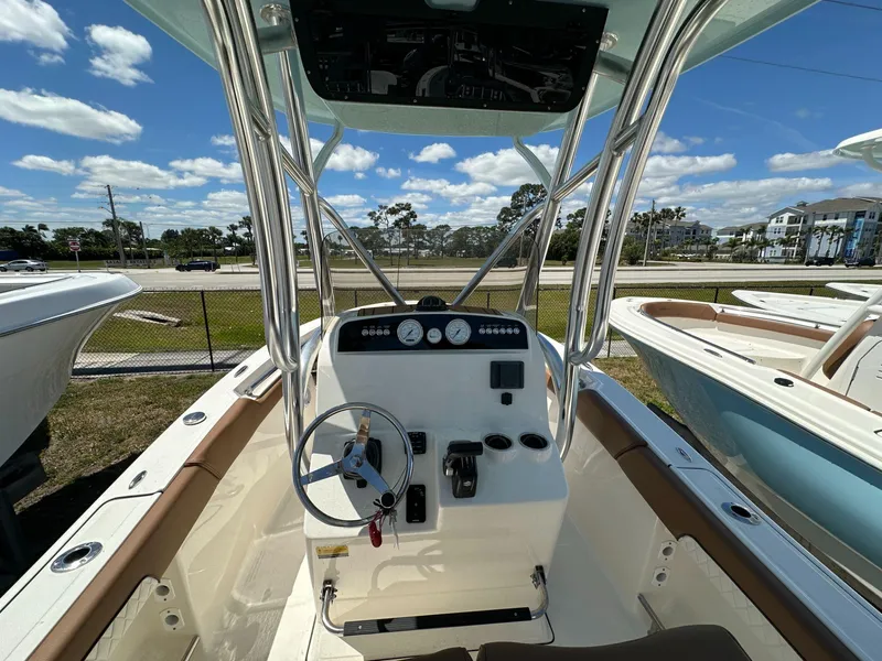 Slide: The Image of 2024 Pioneer 222 Sport Fish boat interior with steering wheel and controls. - 4