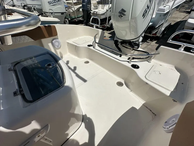 Slide: The Image of 2024 Pioneer 222 Sport Fish storage compartment interior with hatch and light. - 8