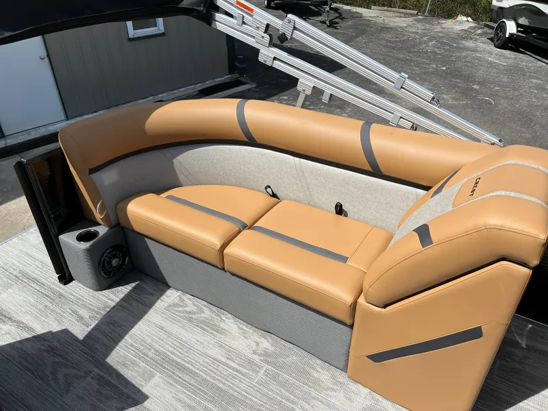 Slide: The Image of 2024 Crest Classic LX 220 boat with tan and gray seating. - 11