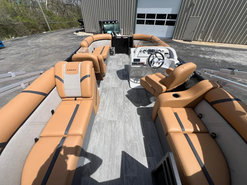 Slide: The Image of 2024 Crest Classic LX 220 pontoon boat with tan seating and modern helm. - 12
