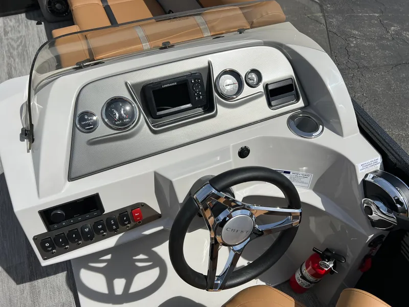 Slide: The Image of 2024 Crest Classic LX 220 boat dashboard with steering wheel and control panel. - 15