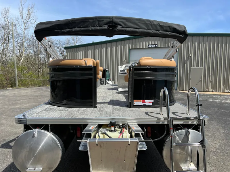 Slide: The Image of 2024 Crest Classic LX 220 pontoon boat with black and tan seating. - 5