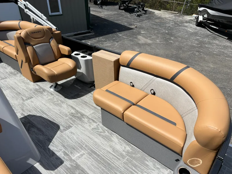 Slide: The Image of 2024 Crest Classic LX 220 boat interior with tan and gray seating. - 8
