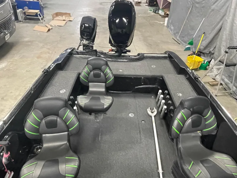 Slide: The Image of 2020 Nitro ZV21 fishing boat interior with black and green seats in a garage. - 14