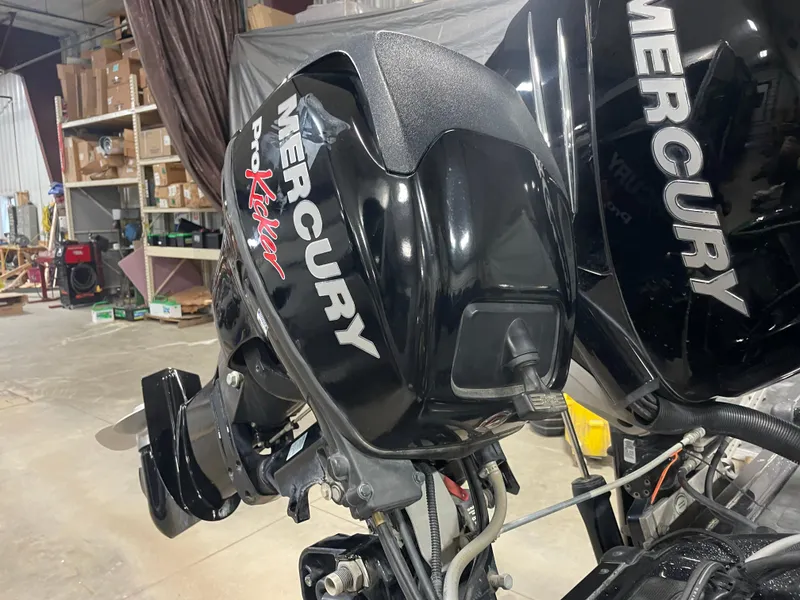Slide: The Image of Mercury Pro Kicker outboard motor on a 2020 Nitro ZV21 boat in a workshop. - 16