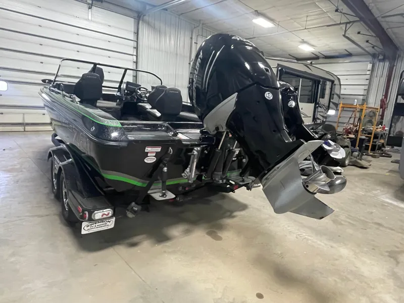 Slide: The Image of 2020 Nitro ZV21 boat in a garage, featuring a powerful outboard motor. - 5