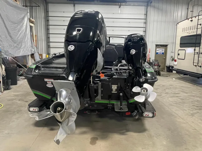 Slide: The Image of 2020 Nitro ZV21 boat with dual outboard motors in a garage. - 6