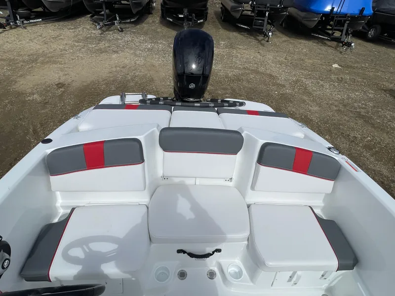 Slide: The Image of 2024 Tahoe T16 boat interior with gray and red seating, outboard motor in background. - 10