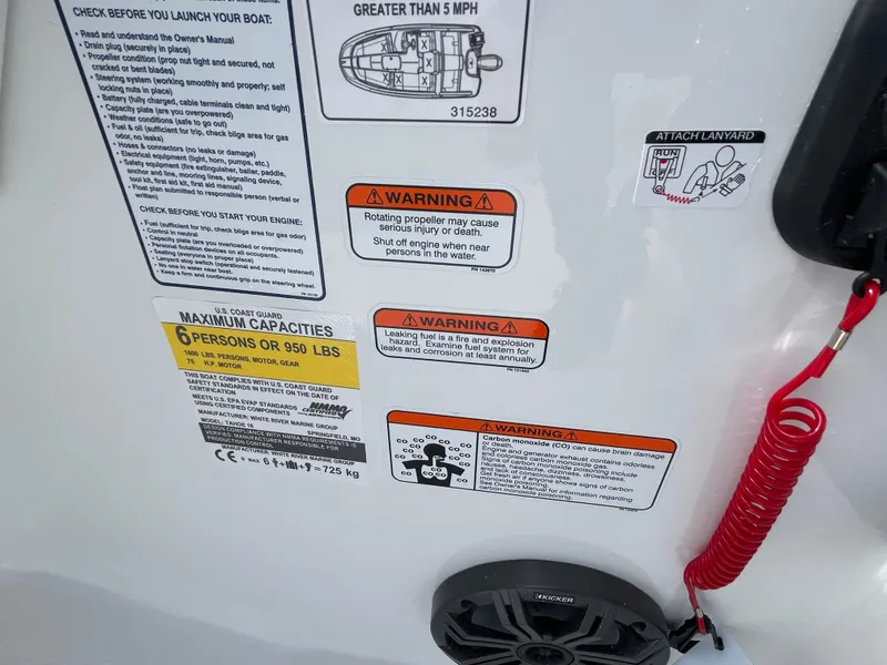 Slide: The Image of 2024 Tahoe T16 boat safety and capacity warning labels. - 13