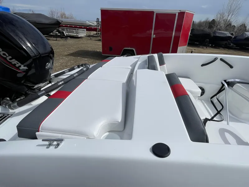 Slide: The Image of 2024 Tahoe T16 boat with Mercury engine and red trailer in background. - 7