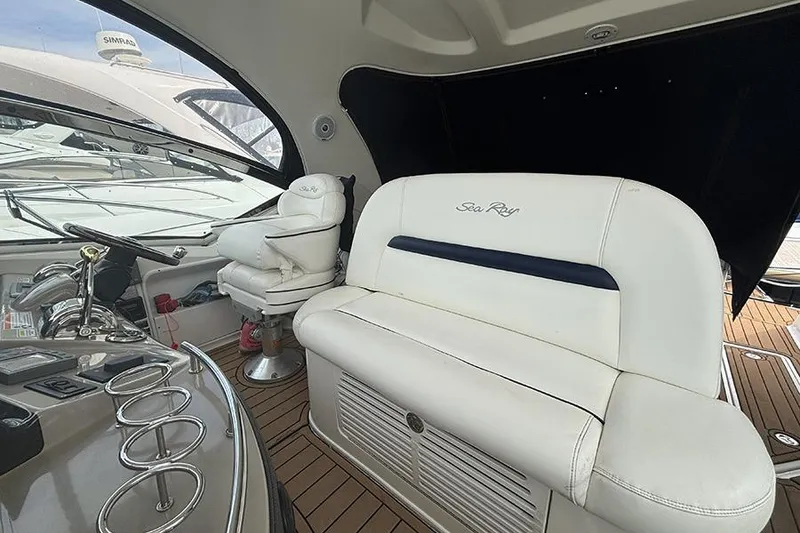 Slide: The Image of Interior of 2006 Sea Ray 44 Sundancer yacht with white seating and control panel. - 14