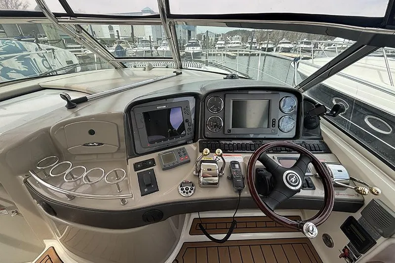 Slide: The Image of Helm of 2006 Sea Ray 44 Sundancer with navigation instruments and steering wheel. - 16