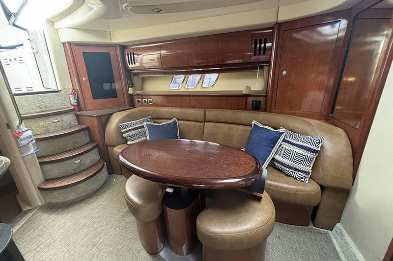 Slide: The Image of Luxurious interior of 2006 Sea Ray 44 Sundancer yacht with plush seating and wooden table. - 18