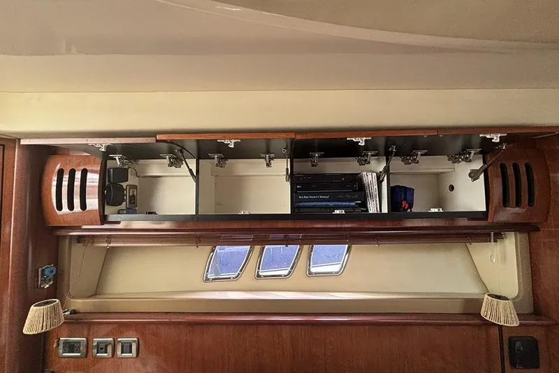 Slide: The Image of Open cabinet in 2006 Sea Ray 44 Sundancer yacht interior, showcasing storage space and equipment. - 19