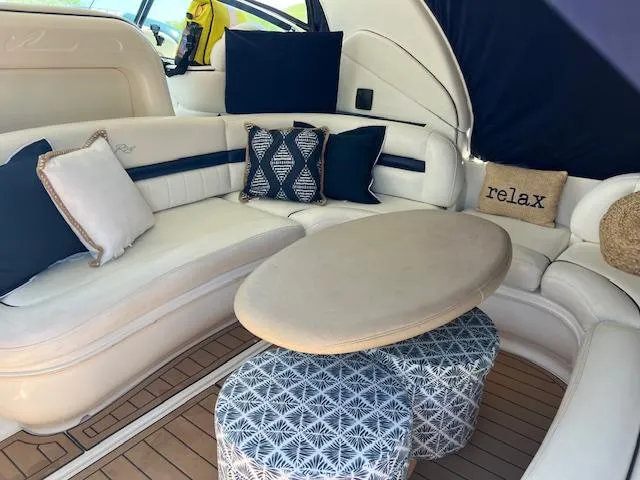 Slide: The Image of 2006 Sea Ray 44 Sundancer yacht docked with inflatable boat, under cloudy sky. - 2