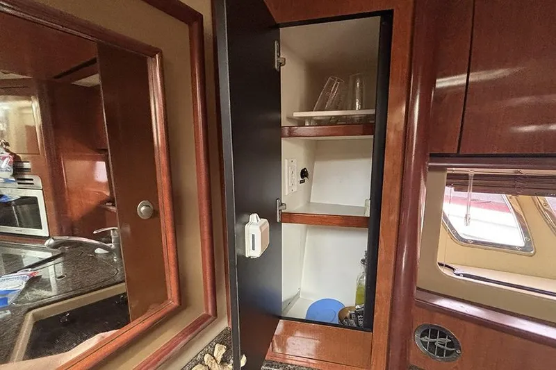 Slide: The Image of Interior cabinet of 2006 Sea Ray 44 Sundancer yacht with shelves and glassware. - 28