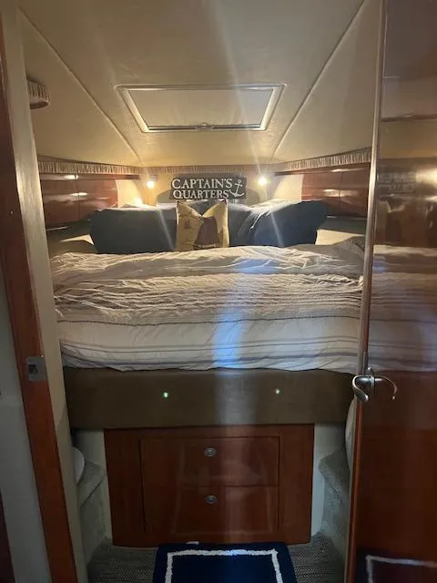 Slide: The Image of 2006 Sea Ray 44 Sundancer yacht docked at marina under cloudy sky. - 3