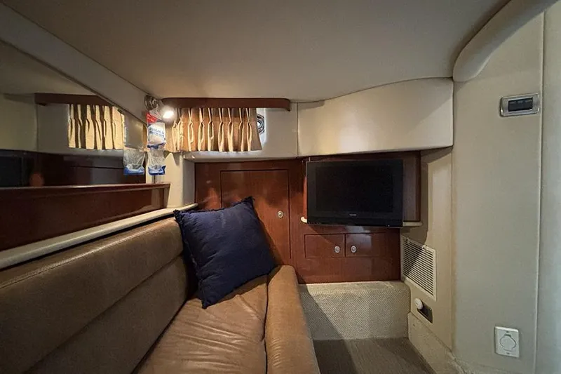Slide: The Image of Interior of 2006 Sea Ray 44 Sundancer yacht with sofa, TV, and wooden cabinetry. - 34