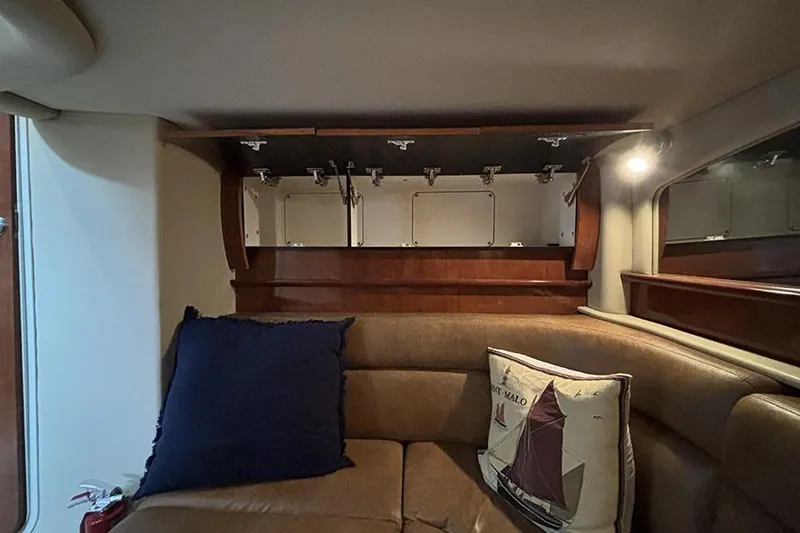 Slide: The Image of Interior of 2006 Sea Ray 44 Sundancer with leather seating and nautical-themed pillows. - 36