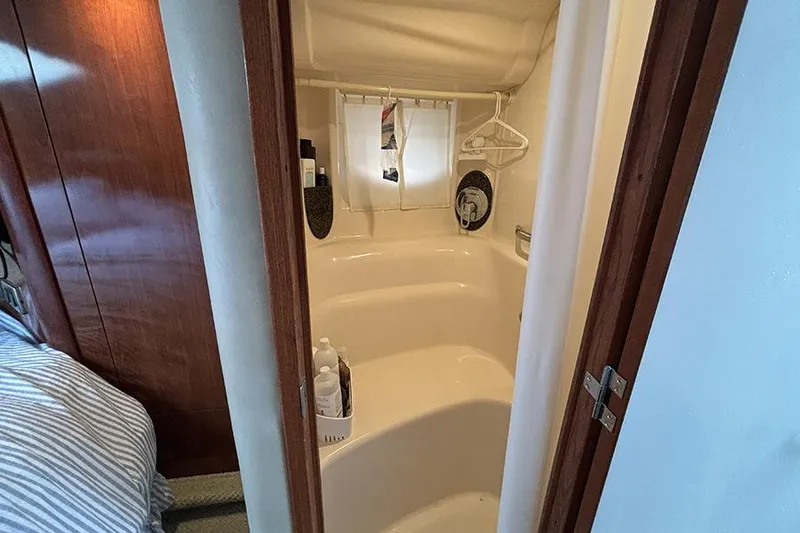 Slide: The Image of Interior of 2006 Sea Ray 44 Sundancer yacht showing compact bathroom with shower. - 44
