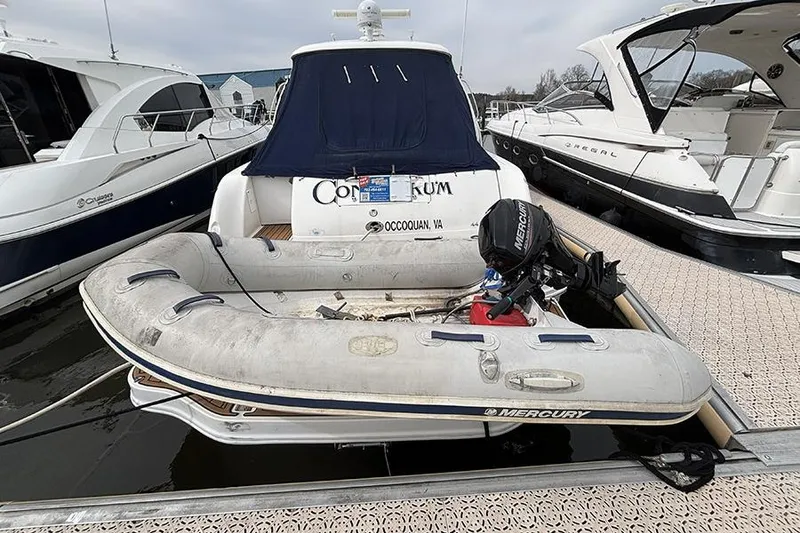 Slide: The Image of 2006 Sea Ray 44 Sundancer docked with inflatable Mercury dinghy attached. - 48