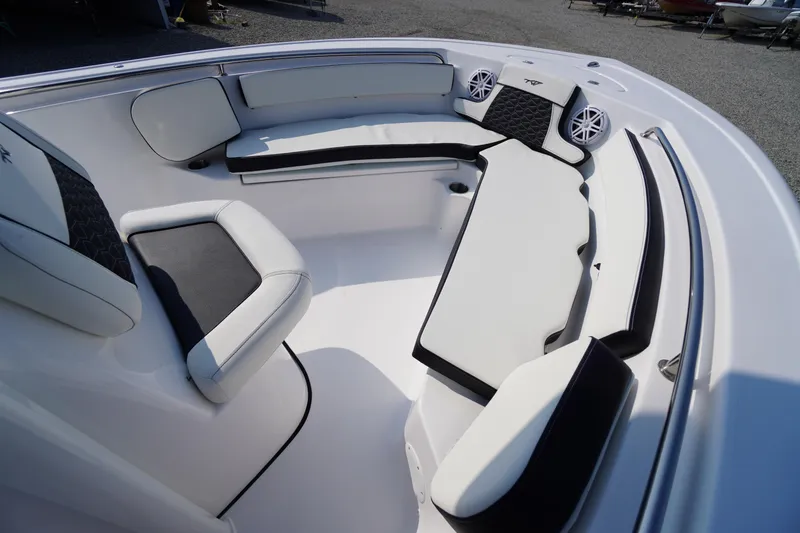 Slide: The Image of 2026 Tidewater 210 CC Adventure boat interior with cushioned seating and speakers. - 10