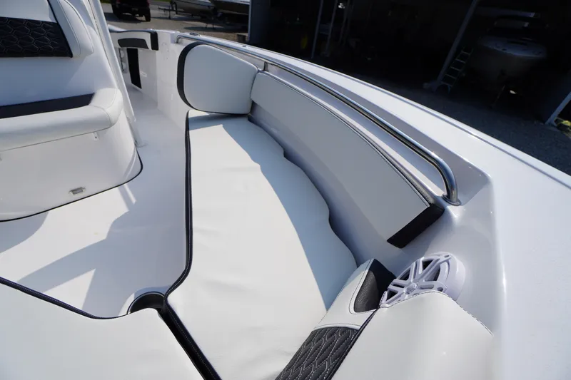Slide: The Image of 2026 Tidewater 210 CC Adventure boat interior with cushioned seating and stainless steel railing. - 12