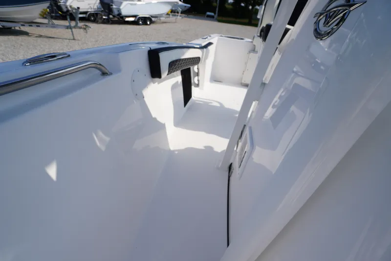 Slide: The Image of 2026 Tidewater 210 CC Adventure boat interior, showcasing sleek white design and seating. - 18