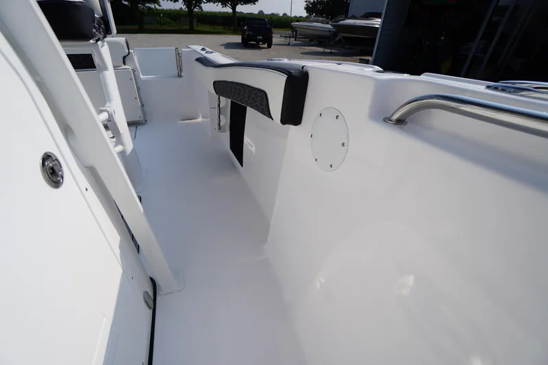 Slide: The Image of 2026 Tidewater 210 CC Adventure boat interior with sleek white design and stainless steel railings. - 19