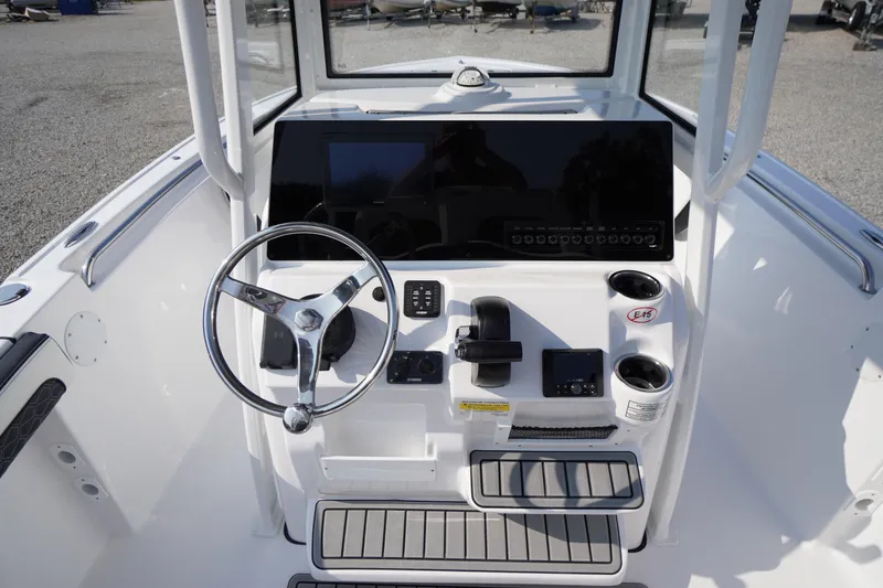 Slide: The Image of 2026 Tidewater 210 CC Adventure boat console with steering wheel and controls. - 25