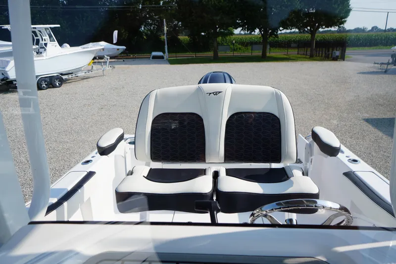 Slide: The Image of 2026 Tidewater 210 CC Adventure boat interior with dual seats and steering wheel. - 32