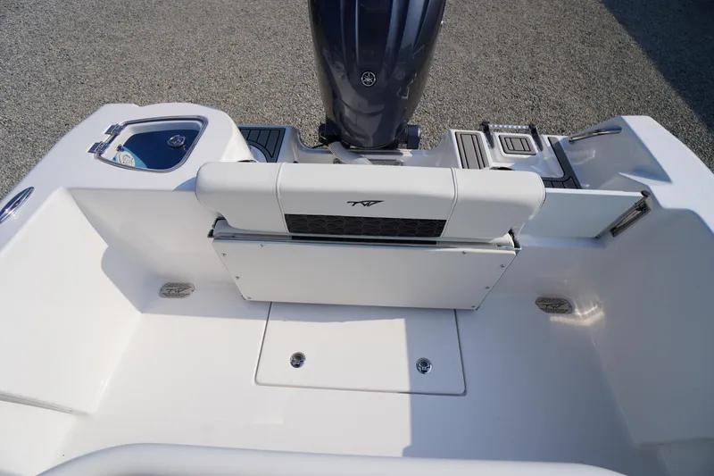 Slide: The Image of 2026 Tidewater 210 CC Adventure boat interior with seating and engine view. - 34