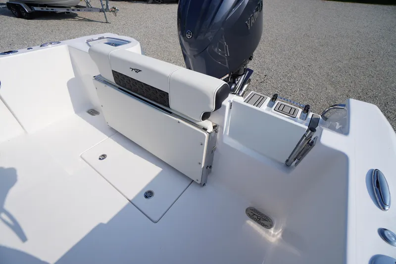 Slide: The Image of 2026 Tidewater 210 CC Adventure boat interior with seating and engine view. - 35