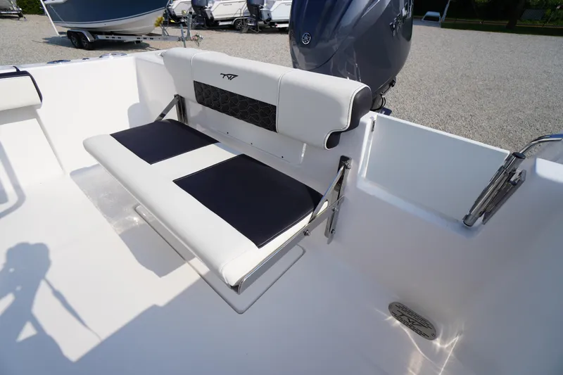 Slide: The Image of 2026 Tidewater 210 CC Adventure boat interior with foldable seating and motor. - 37