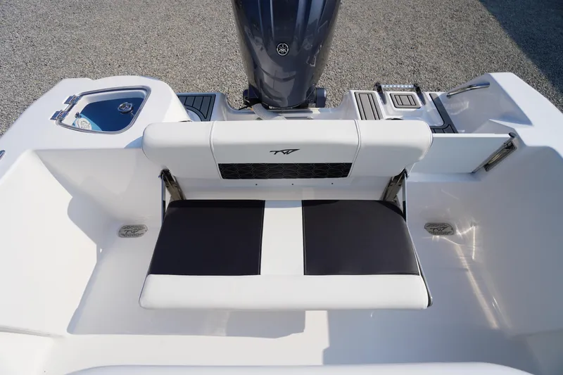 Slide: The Image of 2026 Tidewater 210 CC Adventure boat interior with seating and engine view. - 38