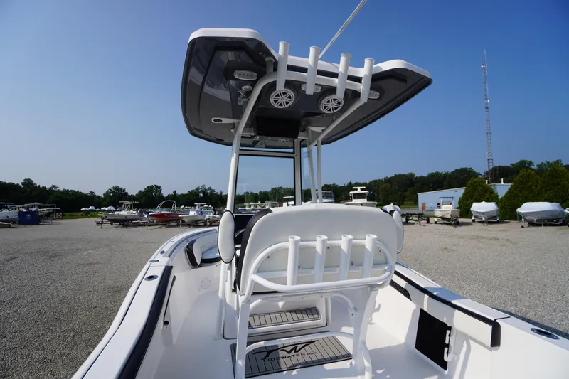 Slide: The Image of 2026 Tidewater 210 CC Adventure boat with T-top and rod holders in a marina setting. - 42